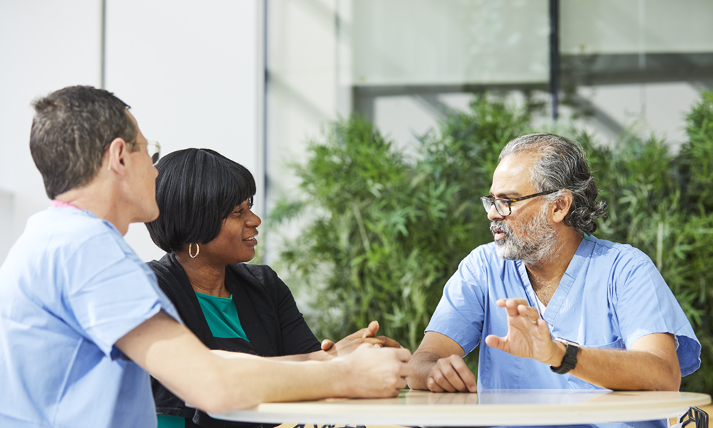 Neurosurgery providers talking to a patient Neurosurgery providers talking to a patient